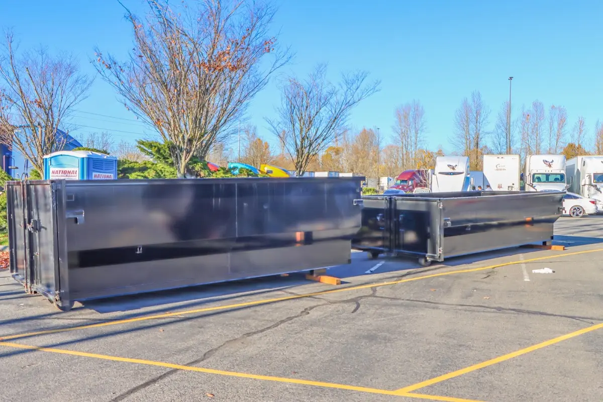 Professional dumpster rental service with roll-off container on residential driveway in Alexandria